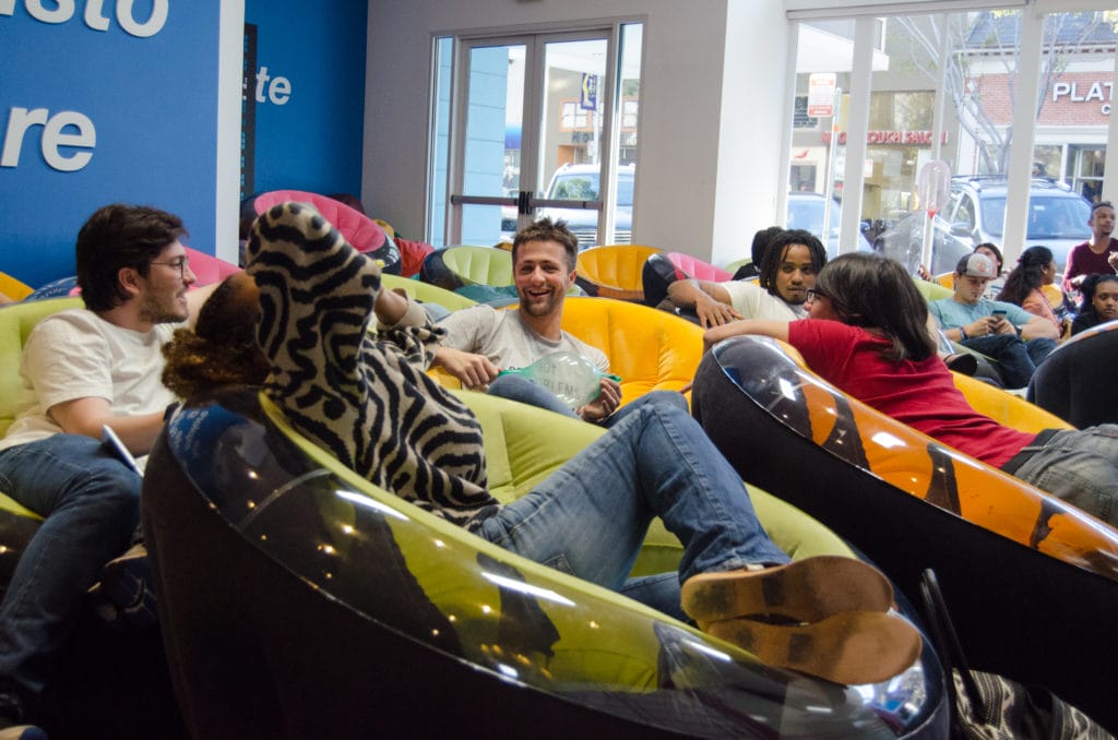 Luke Naji working with his team on creative sales strategies.