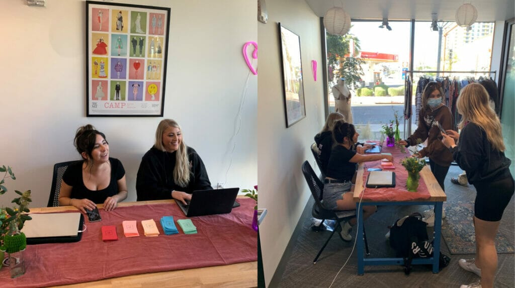 People smiling and sitting at a table and other people checking out at a pop-up retail shop