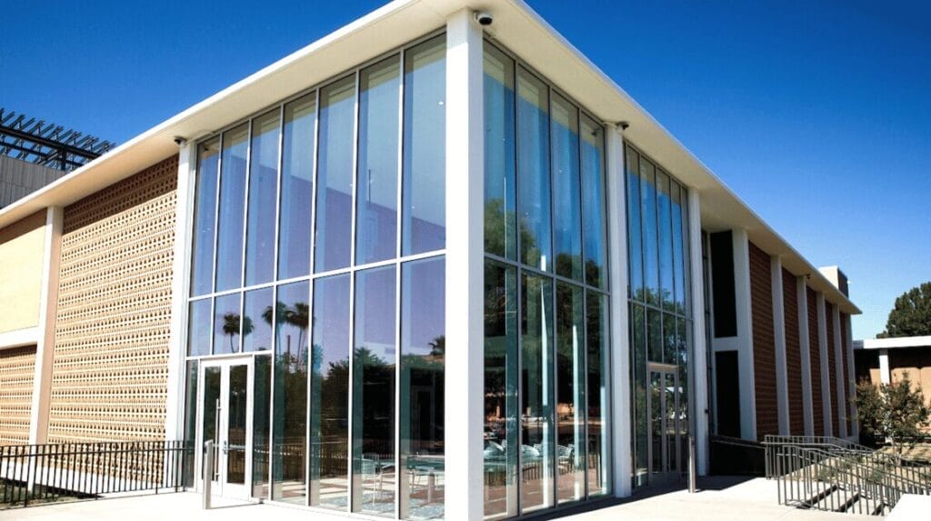Exterior view of a building with floor to ceiling glass windows at The Studios @ Mesa City Center