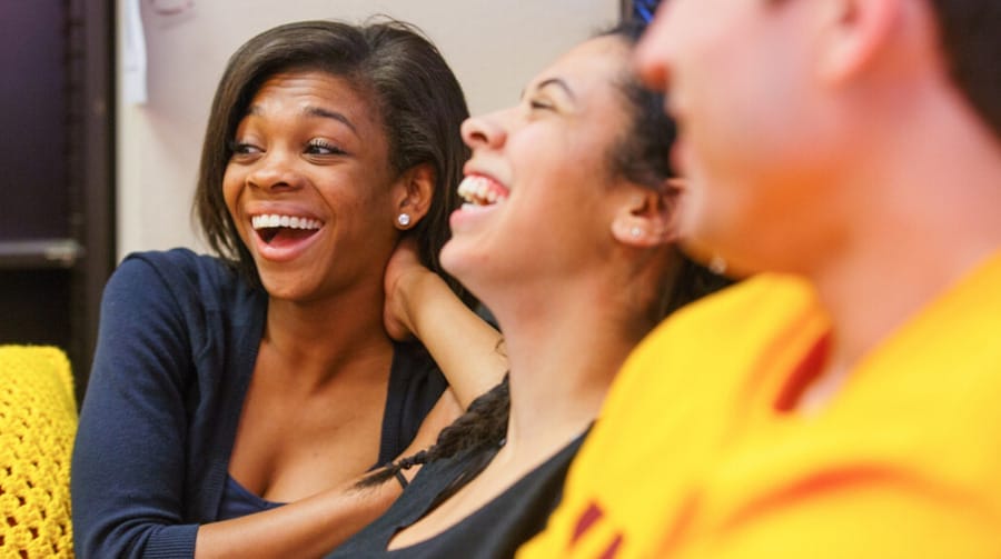 Three people sitting and laughing together at an entrepreneurial event