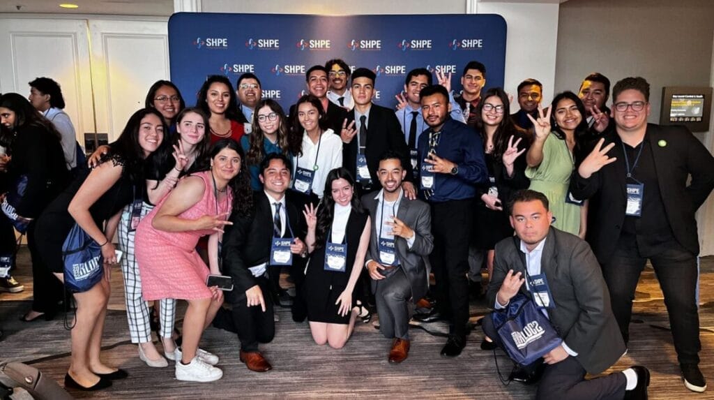 A group of people in business attire smiling at the camera