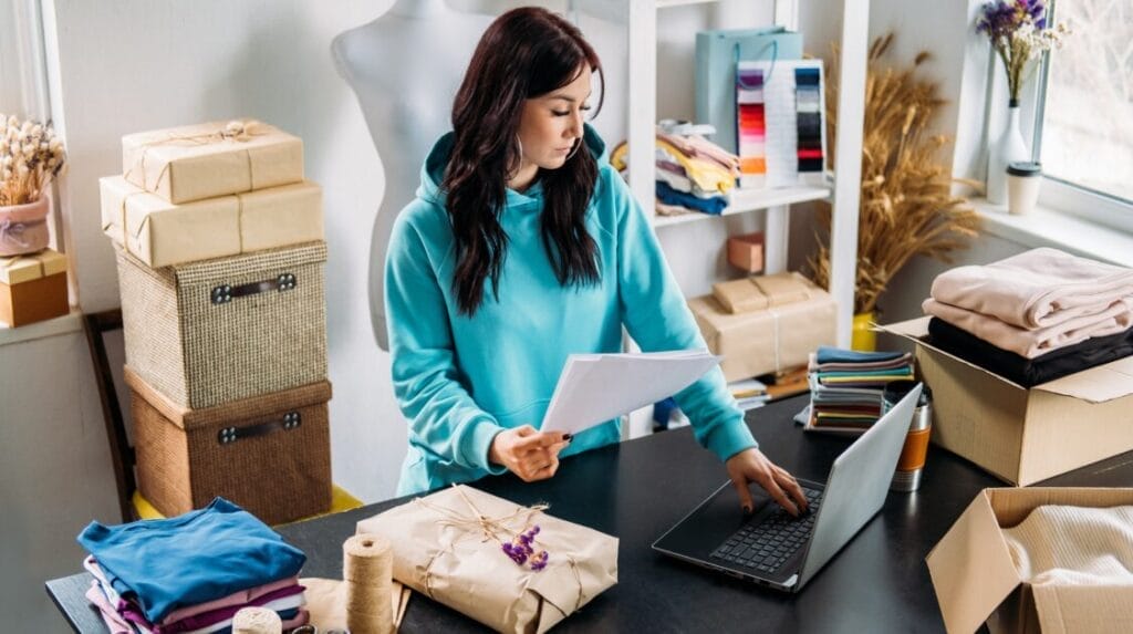 A business owner working on her laptop and shipping products