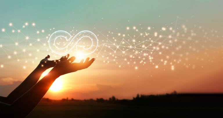 Sunset, silhouette of hands releasing sparkles into the sky