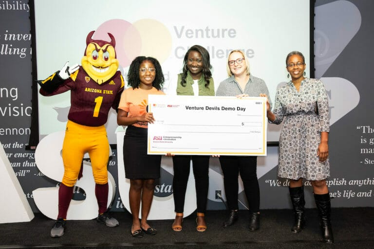 Four women and ASU mascot, Sparky, holding a large check