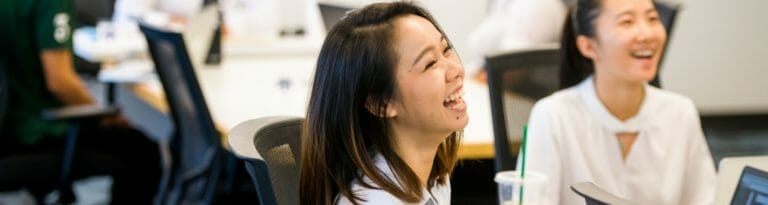 Two students laugh during a class that was part of the Poder program.