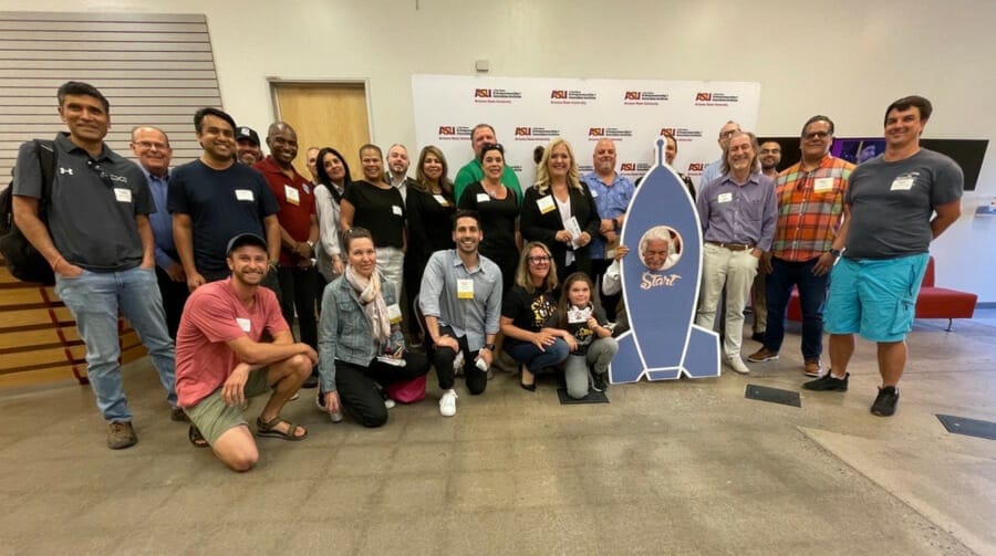 Large group of people posing and smiling at the Chandler Endeavor Venture Innovation Incubator.